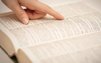 Finger-pointing-to-word-in-dictionary